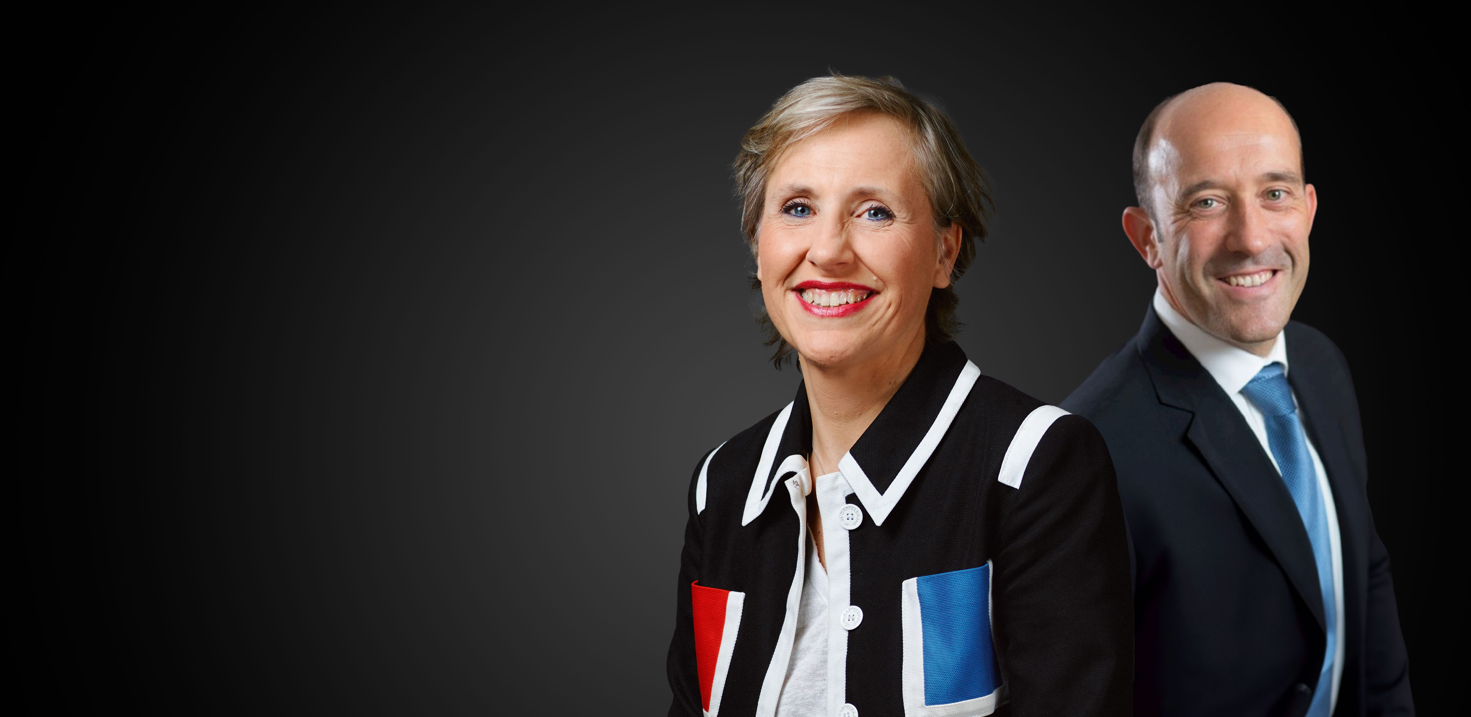 A woman and a man smiling