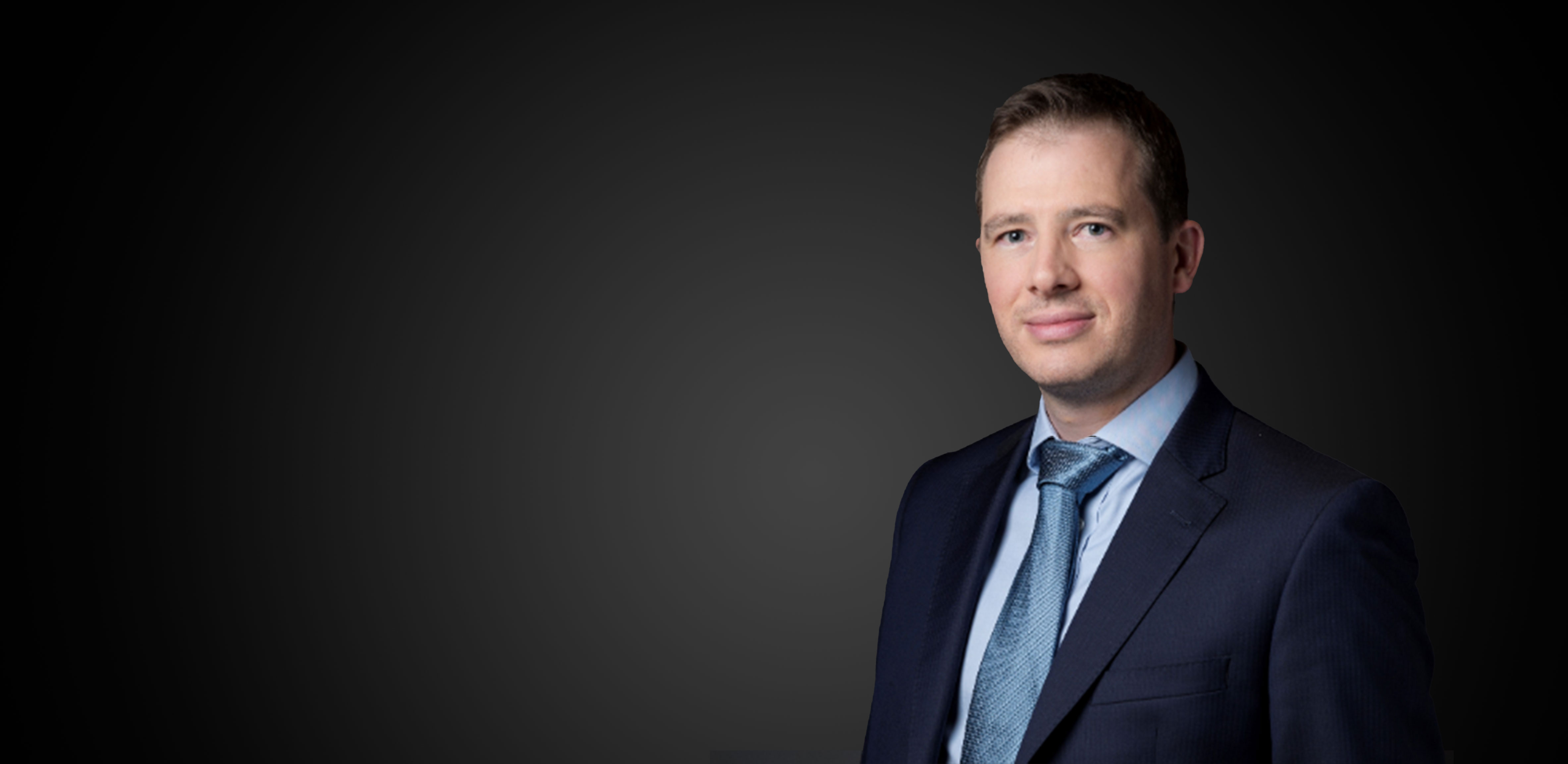 Smiling man dressed in a suit smiling