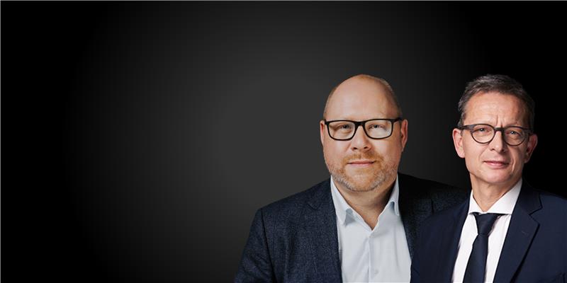 Man dressed in a blue suit, smiling