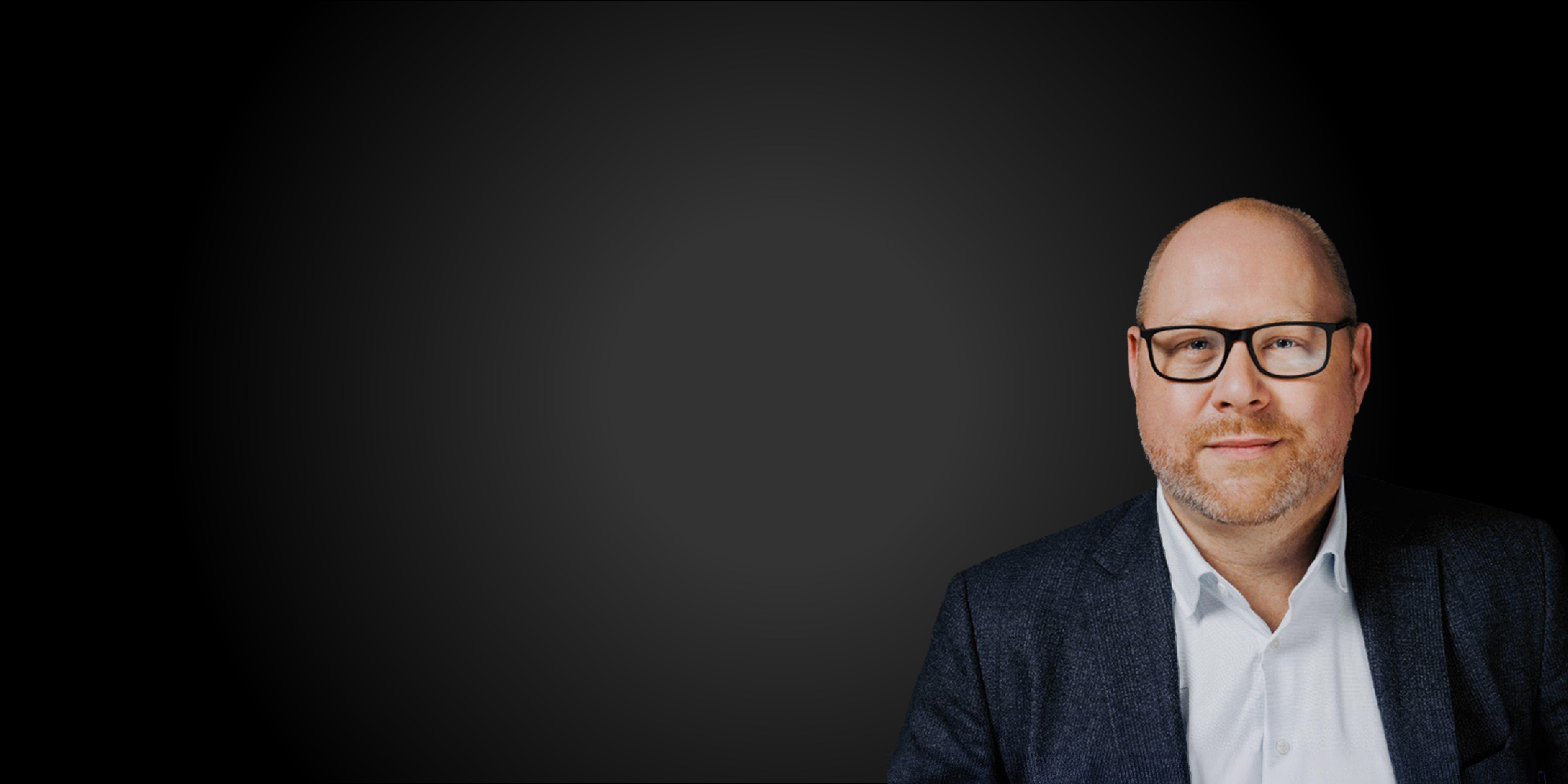 A smiling man dressed in suits