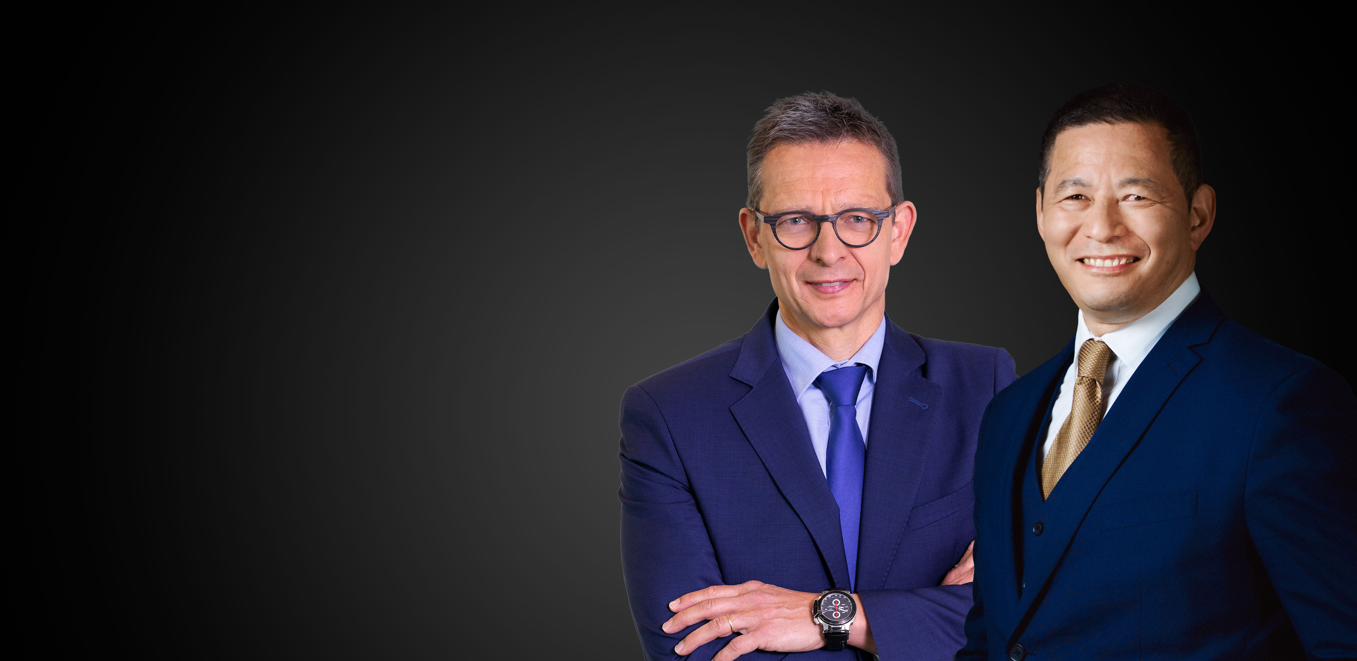 Three men dressed in suits, smiling